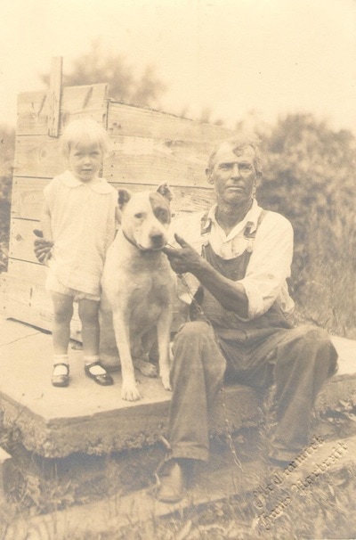 Man seated with Child and Dog