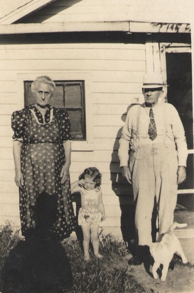 Pike County, Indiana, Unidentified, Elderly Couple Standing in Front of Home with Young Girl and Cat