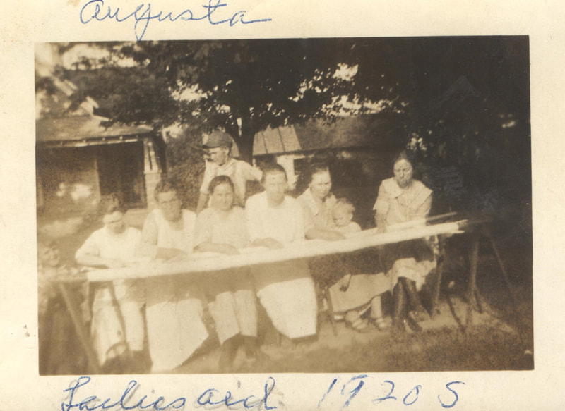 Women seated at table outdoors 
