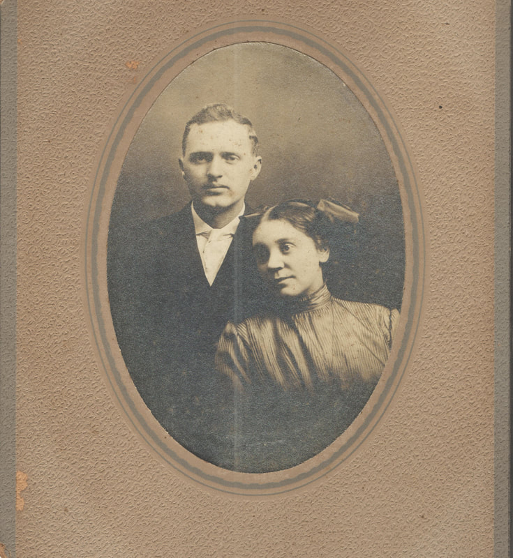 Man and woman seated together in formal dress