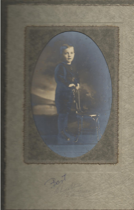 Young boy Standing next to chair