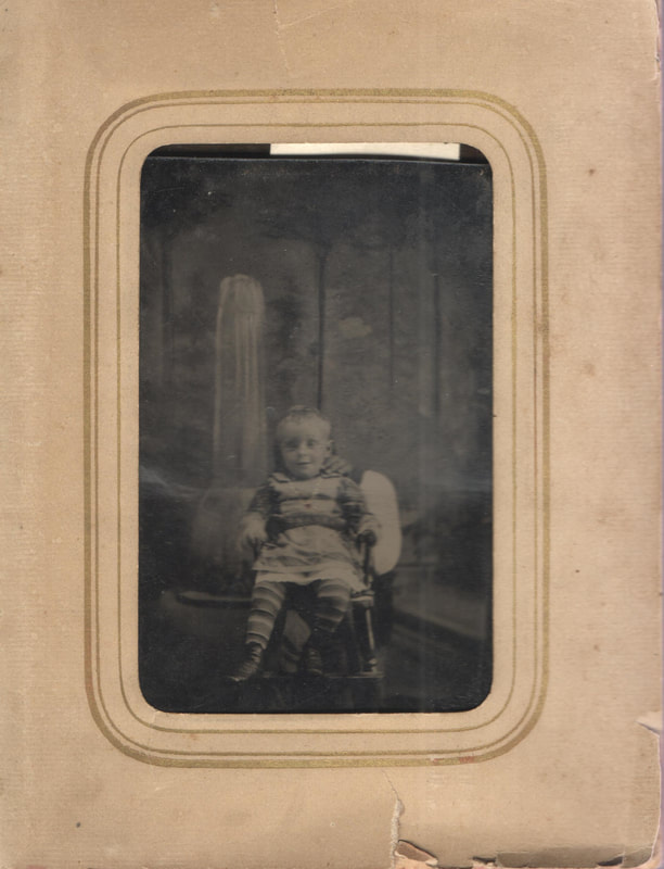 Young boy seated in chair