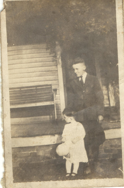 Man standing next to child in Formal Dress in front of home