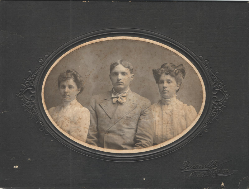 Man seated between two women