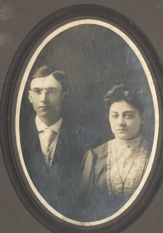 Young man and woman seated together in dress clothes
