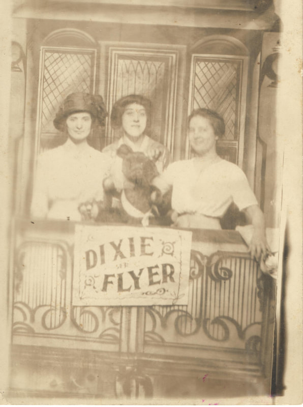 Three young women standing together at Dixie Flyer scenery