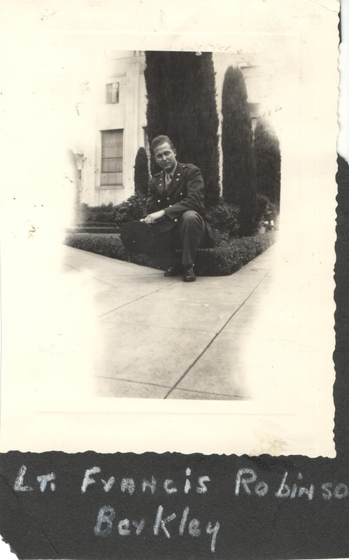 Soldier in uniform crouching in front of building