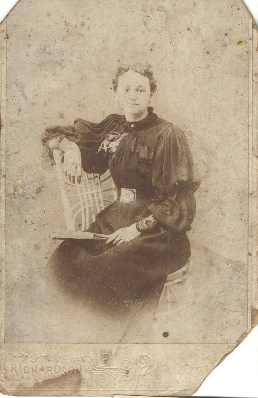 Woman seated in chair holding book