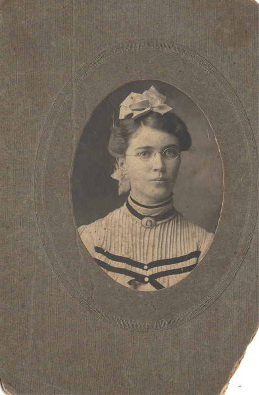 Young woman with glasses and ribbons in hair