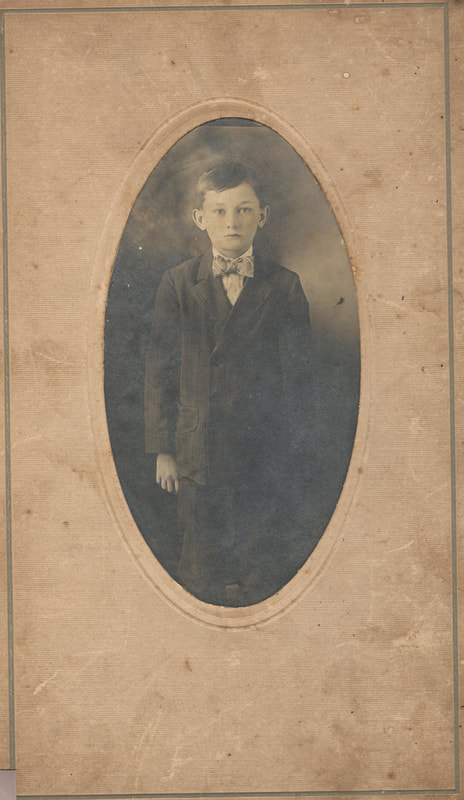 Young boy in suit standing
