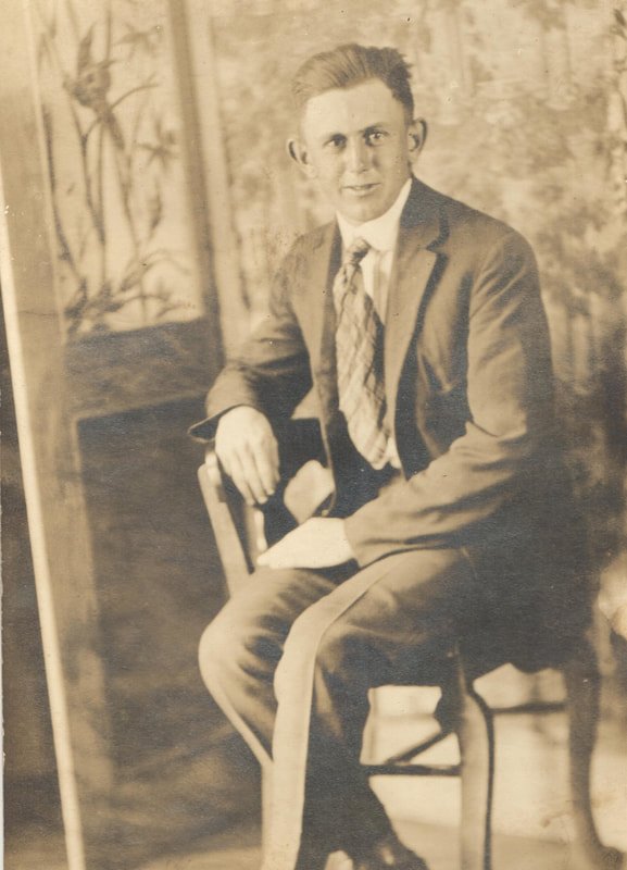 Man in suit sitting on chair