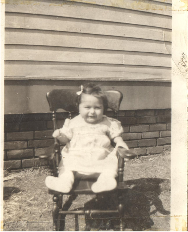 Baby girl sitting on chair
