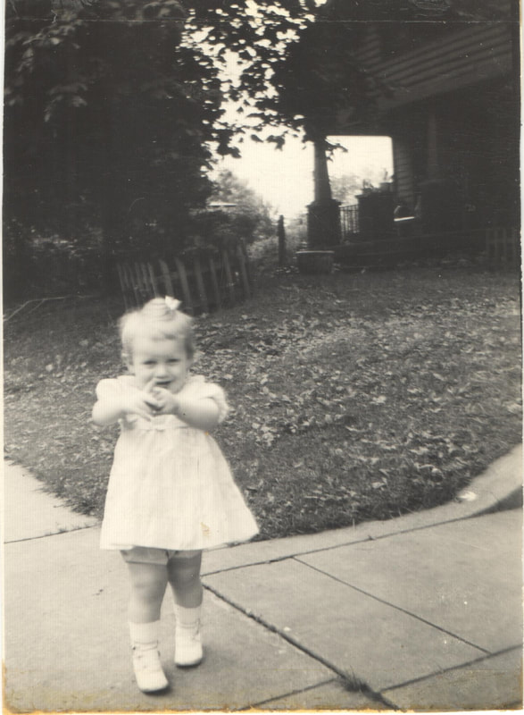 Young girl in dress standing on sidewalk
