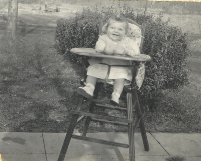 Baby girl seated in high chair