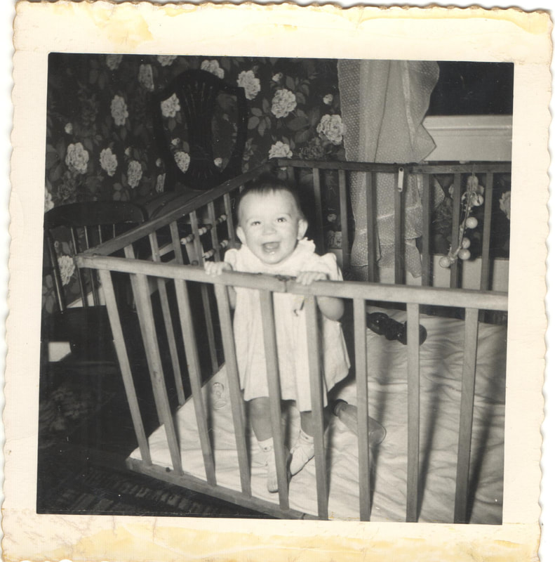 Baby girl standing in crib