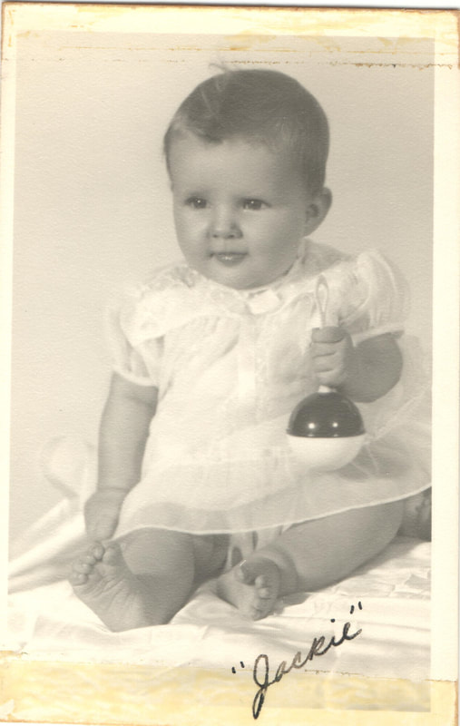 Baby boy holding rattle
