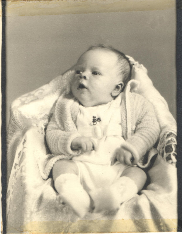 Baby in sweater lying in carriage