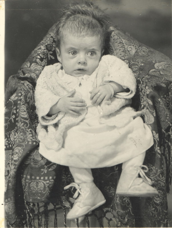 Baby girl seated in chair