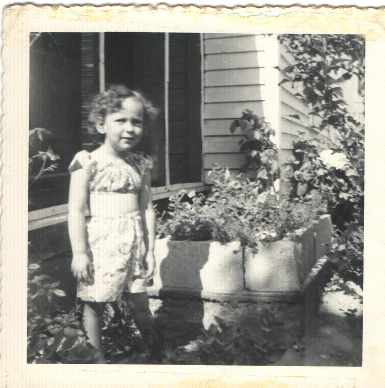 Young girl standing in garden