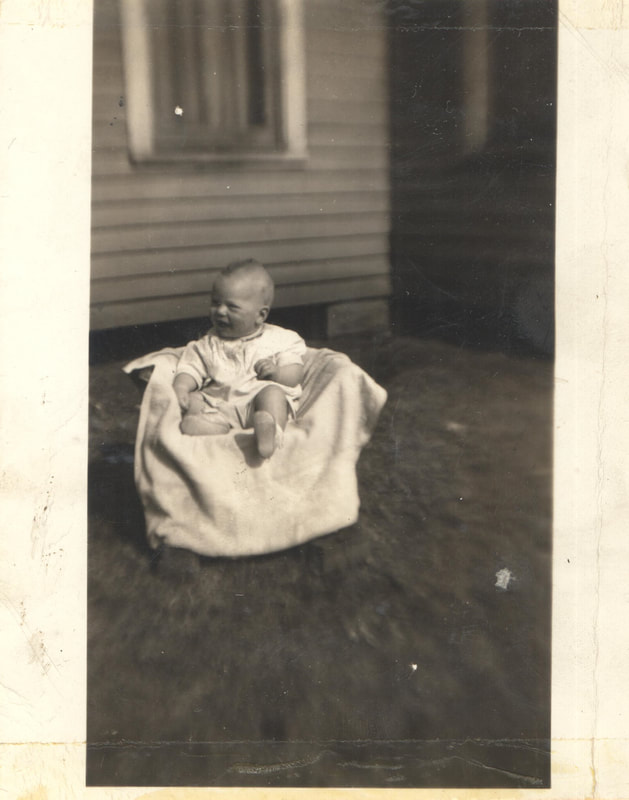 Baby boy seated in chair
