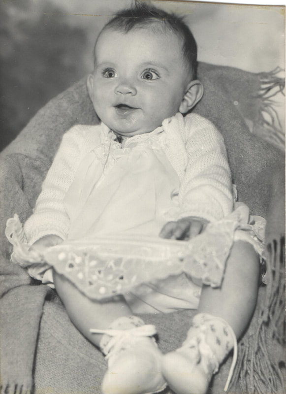 Baby with dark hair seated