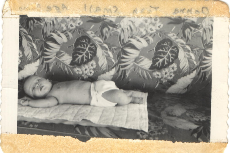 Baby lying on blanket in diaper
