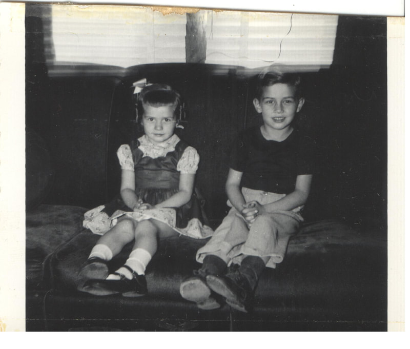 Young boy and girl seated together on couch