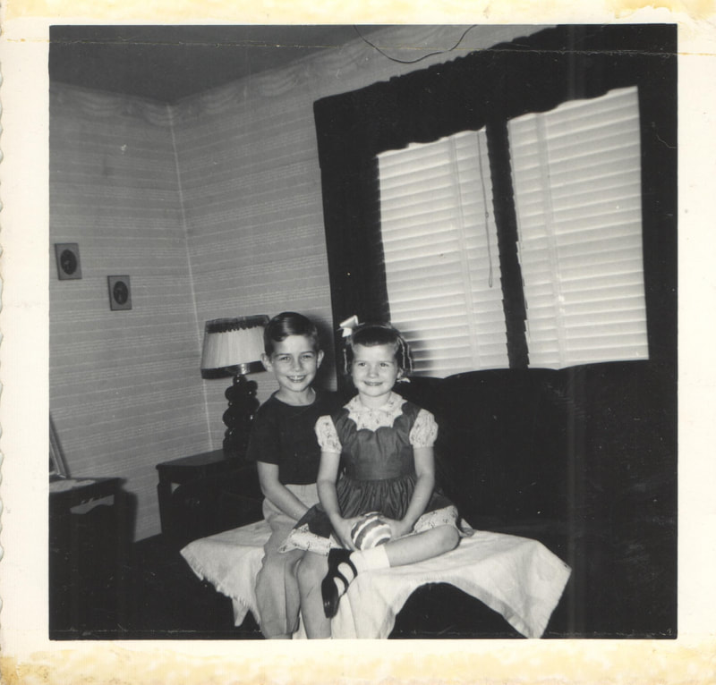 Young boy and girl seated together on couch
