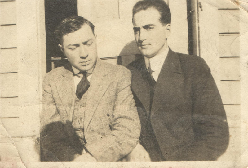 Two men in suits seated next to each other