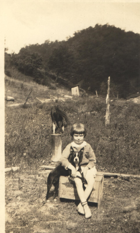 Young girl seated with dog