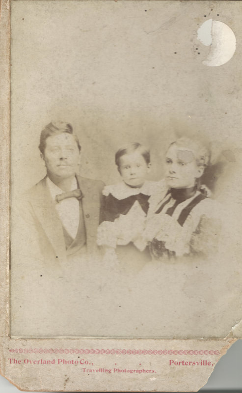 Man, woman, and young child seated together