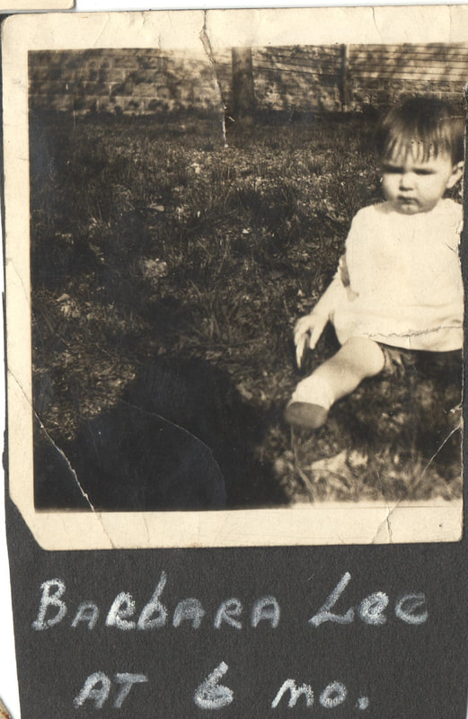 Baby Girl seated in yard
