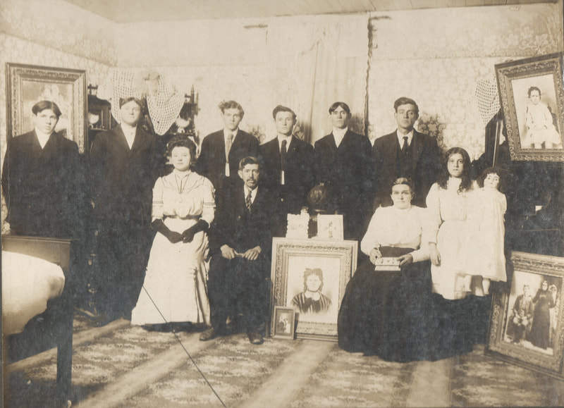 Family gathered together in dress clothing and family portraits