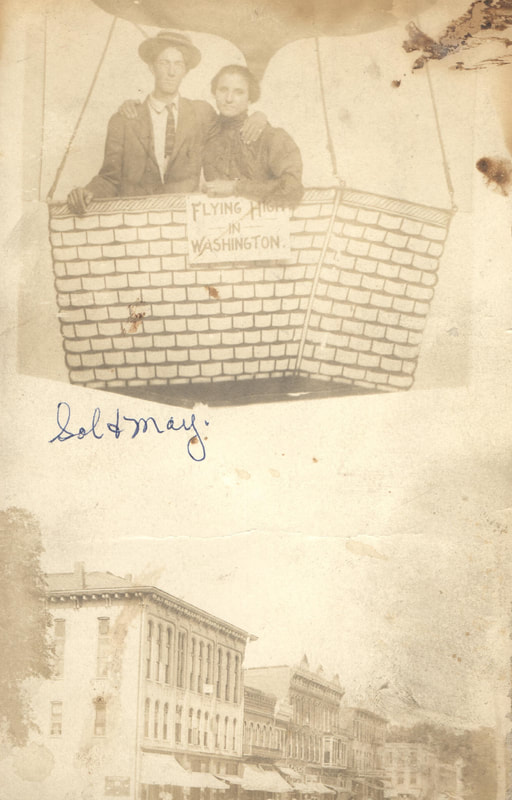 Man and woman standing in basket of hot air balloon, 