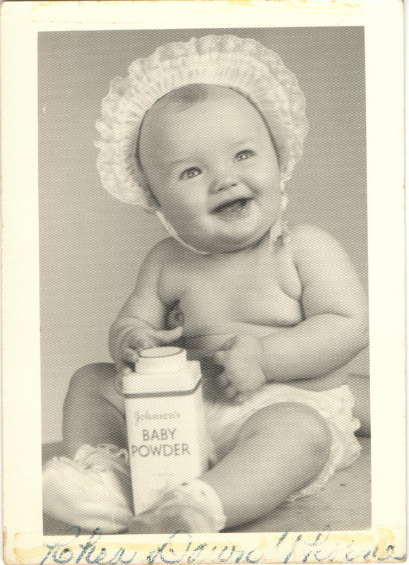 Baby girl in bonnet with Johnson Baby Powder