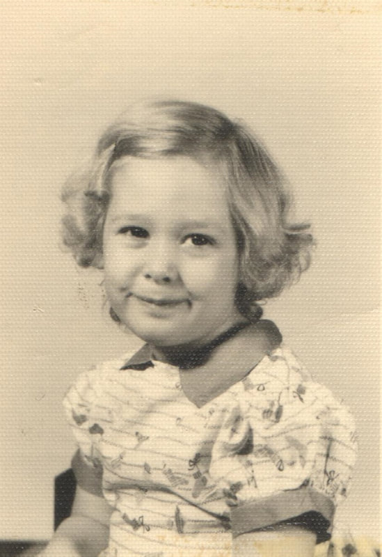 Young girl with blond hair seated