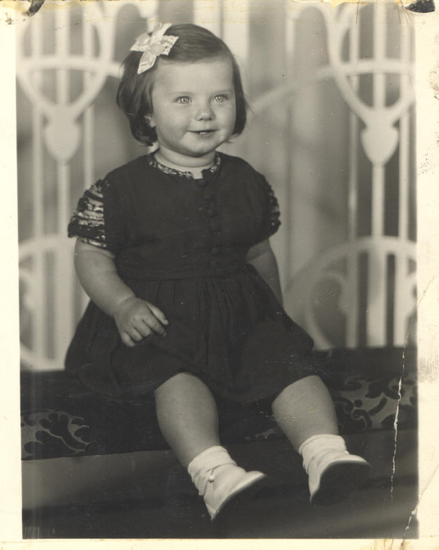 Young girl in black dress seated