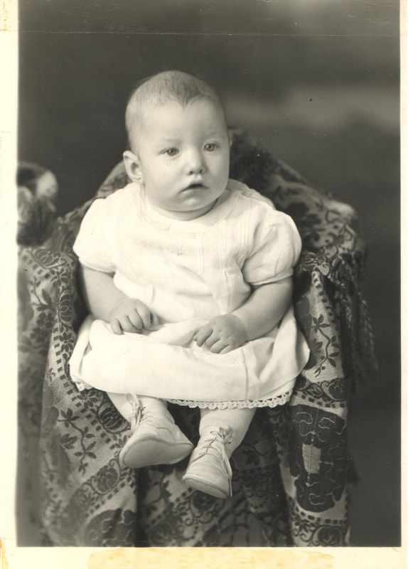 Baby girl seated on chair