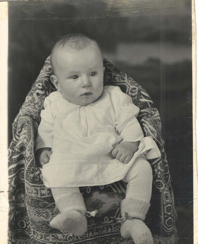 Baby girl seated in chair