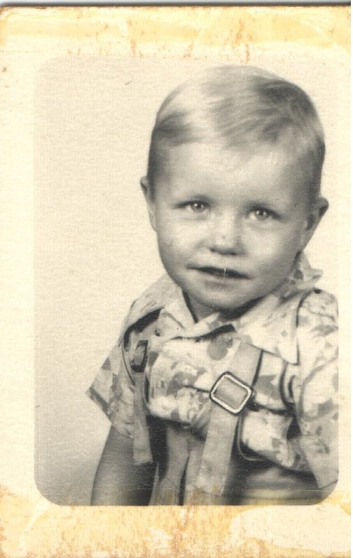 Young boy with blond hair seated