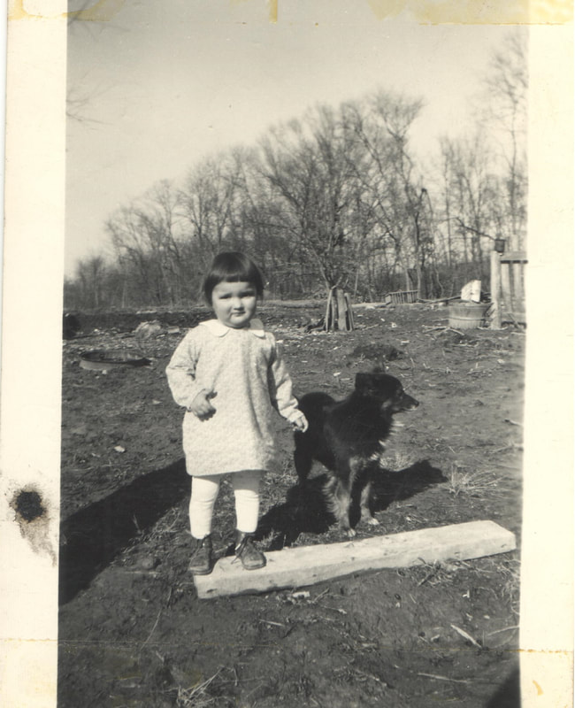 Young girl standing on board next to dog