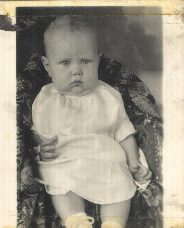 Baby girl seated in carriage