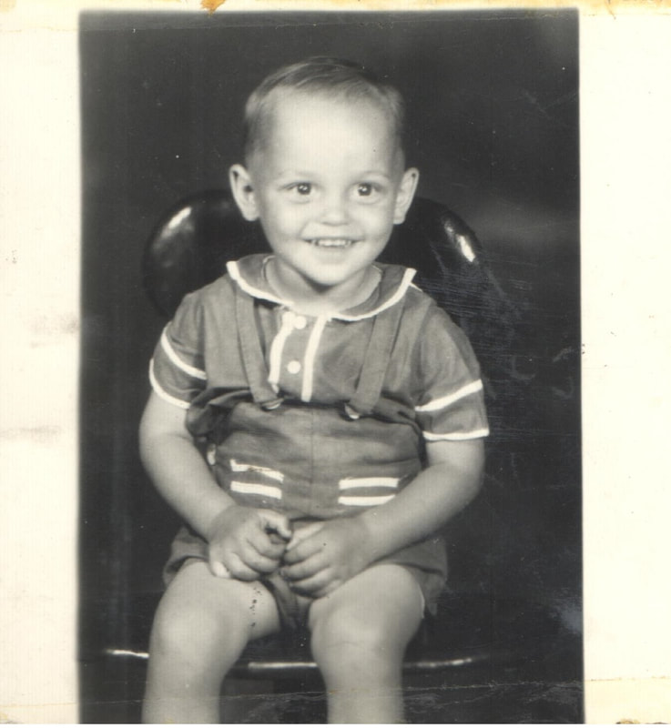 Smiling young boy seated on chair