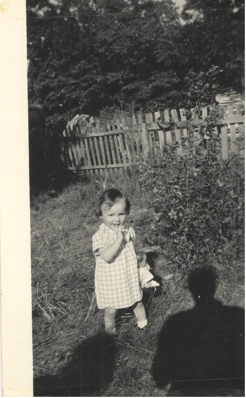 Young girl standing in back yard