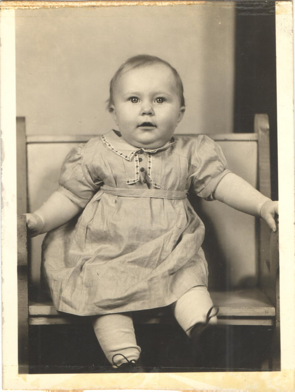 Baby girl in dress seated