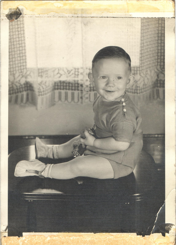 Young boy with toy seated on table