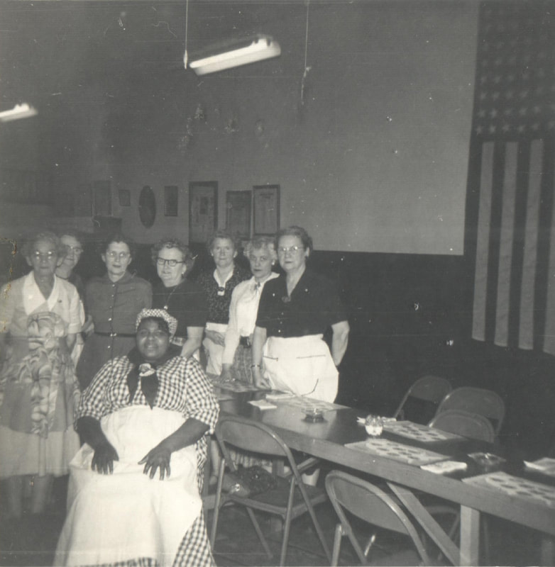 Women standing around table, War Mothers Club, March 1955