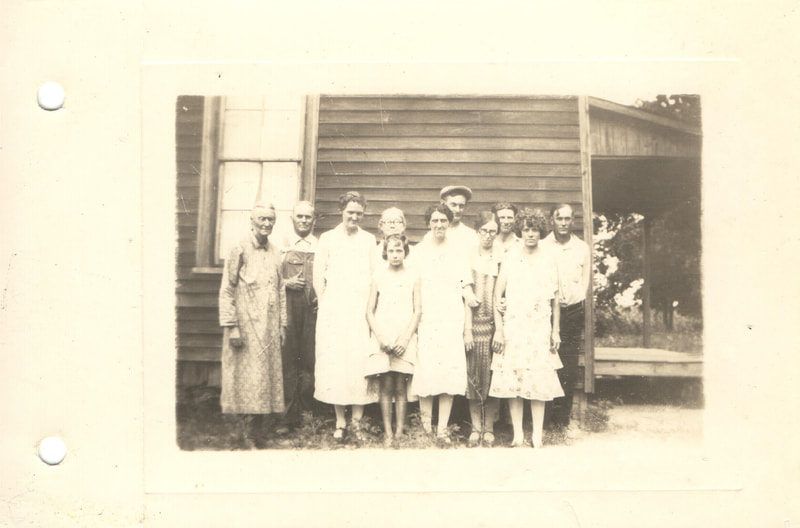 Family standing in front of home