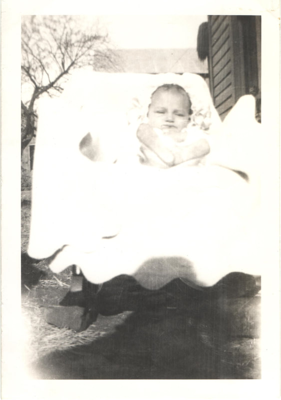 Baby girl seated in carriage