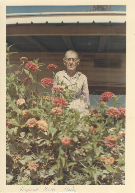 Elderly woman standing in garden